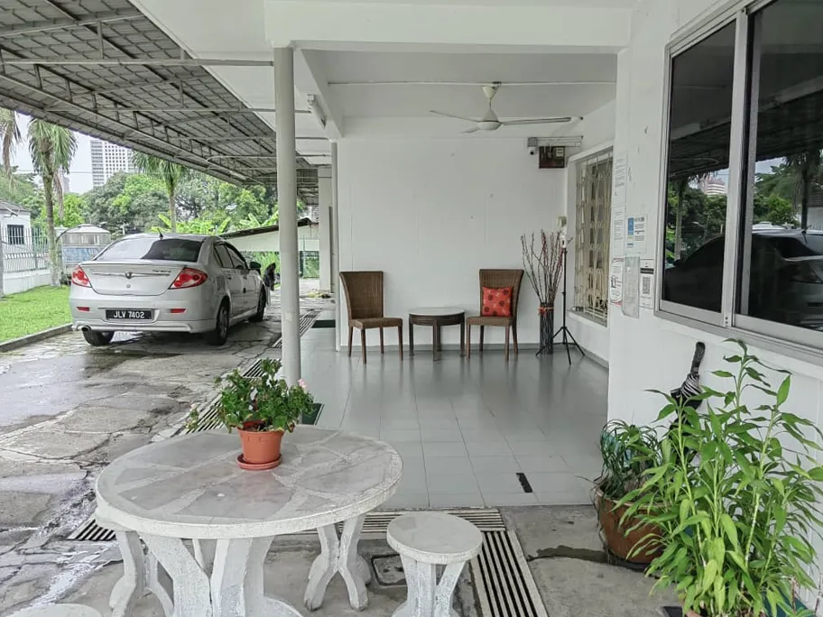 Covered porch outdoor seating area at Green Acres Nursing Home