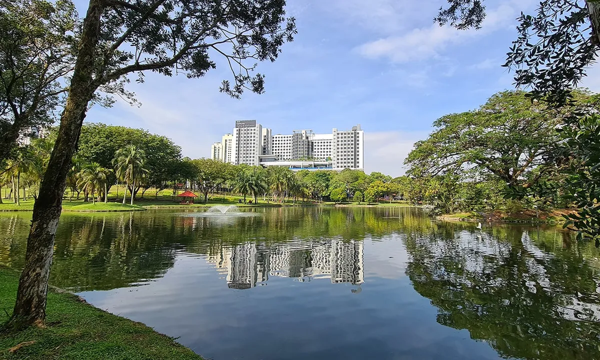Komune Care building viewed from the 99-acre lake park in Cheras