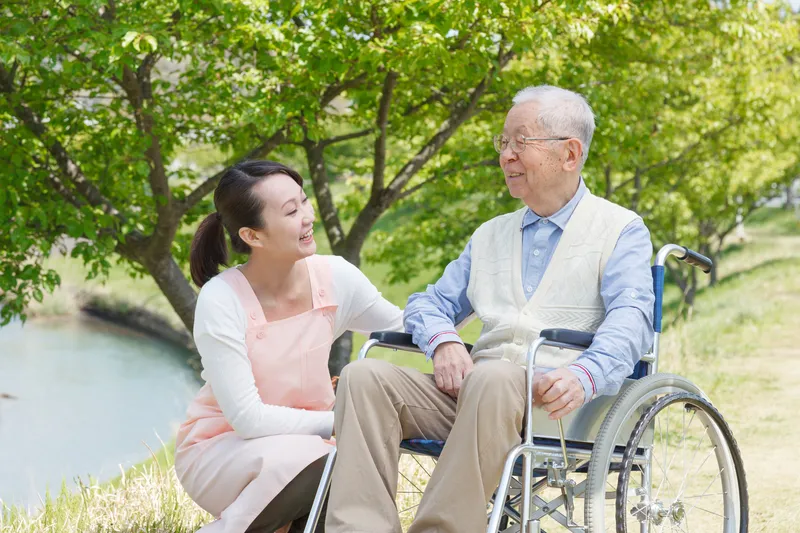 Care staff supporting resident at Jeta Care outdoor area